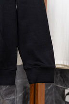 Dark zip-up hoodie sleeve cuff with ribbed trim