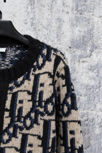 Knit cardigan sleeve with black knit and navy/cream geometric pattern panels