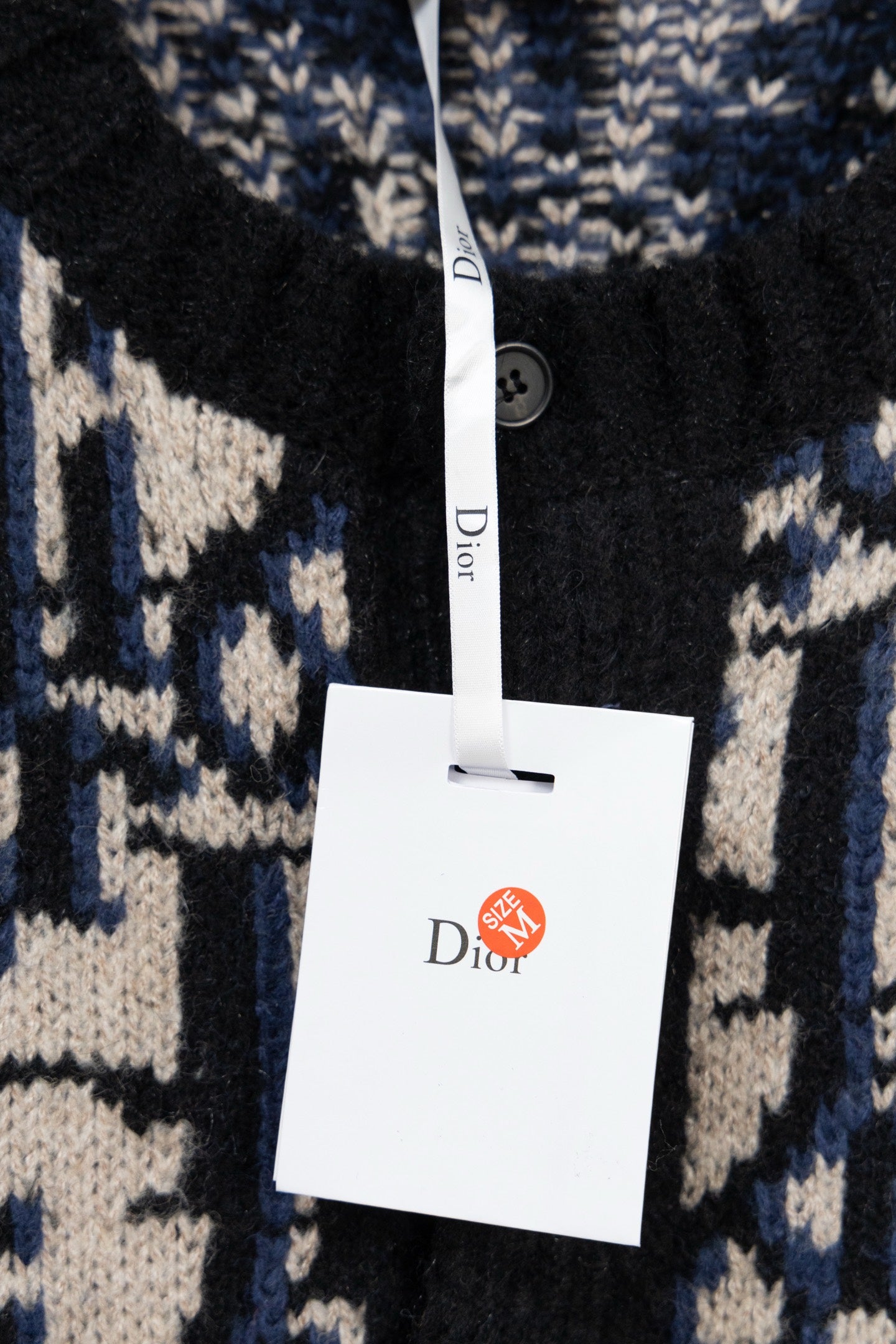Knit cardigan with Dior hang tag and black button front, navy/cream geometric knit