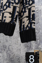 Knit cardigan hem and buttons, black knit with navy and cream geometric pattern