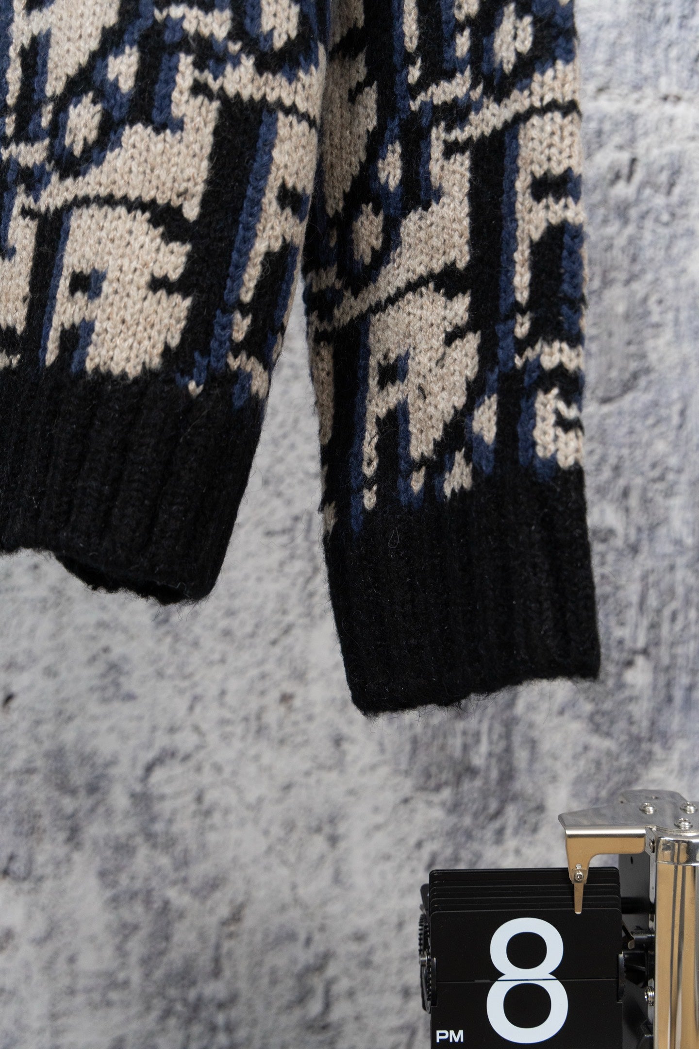 Knit cardigan hem and buttons, black knit with navy and cream geometric pattern