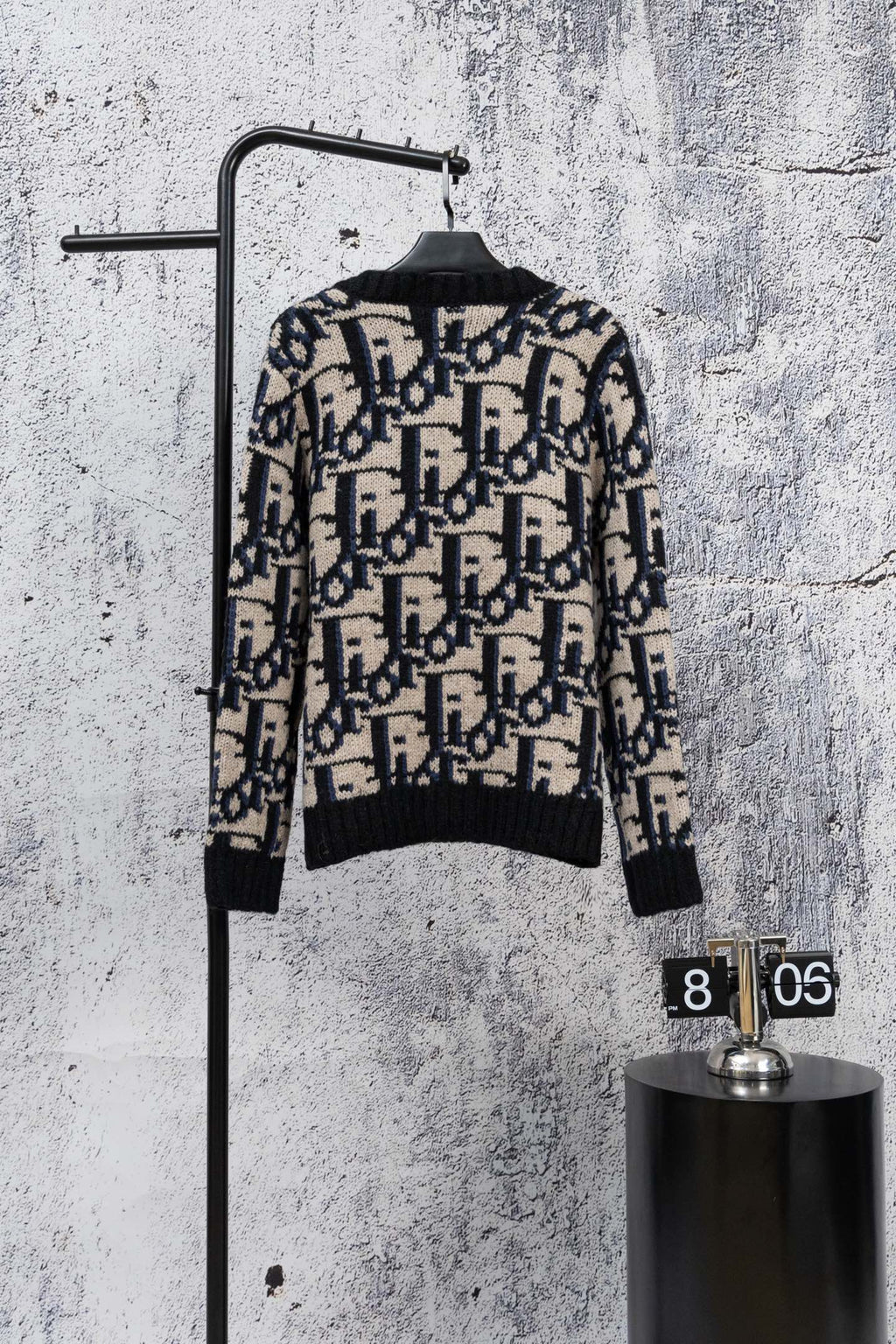 Knit cardigan back view in black with navy and cream geometric jacquard pattern