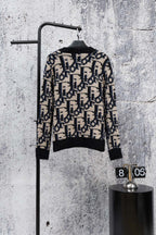 Knit cardigan back view in black with navy and cream geometric jacquard pattern