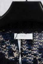 Knit cardigan neckline with black rib trim and blue/cream geometric knit, brand label