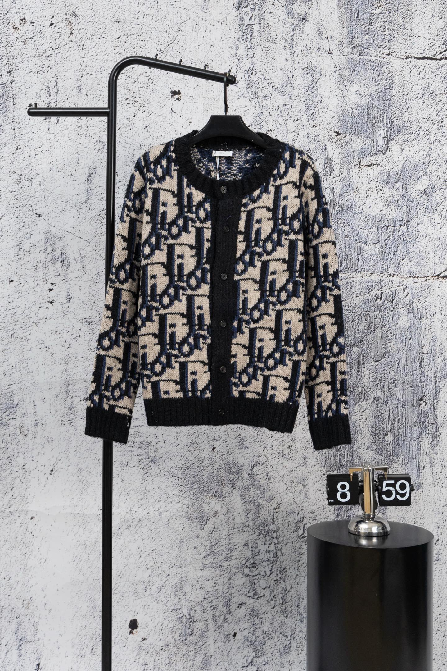 Dior knit cardigan with black base, navy and cream geometric jacquard, button front
