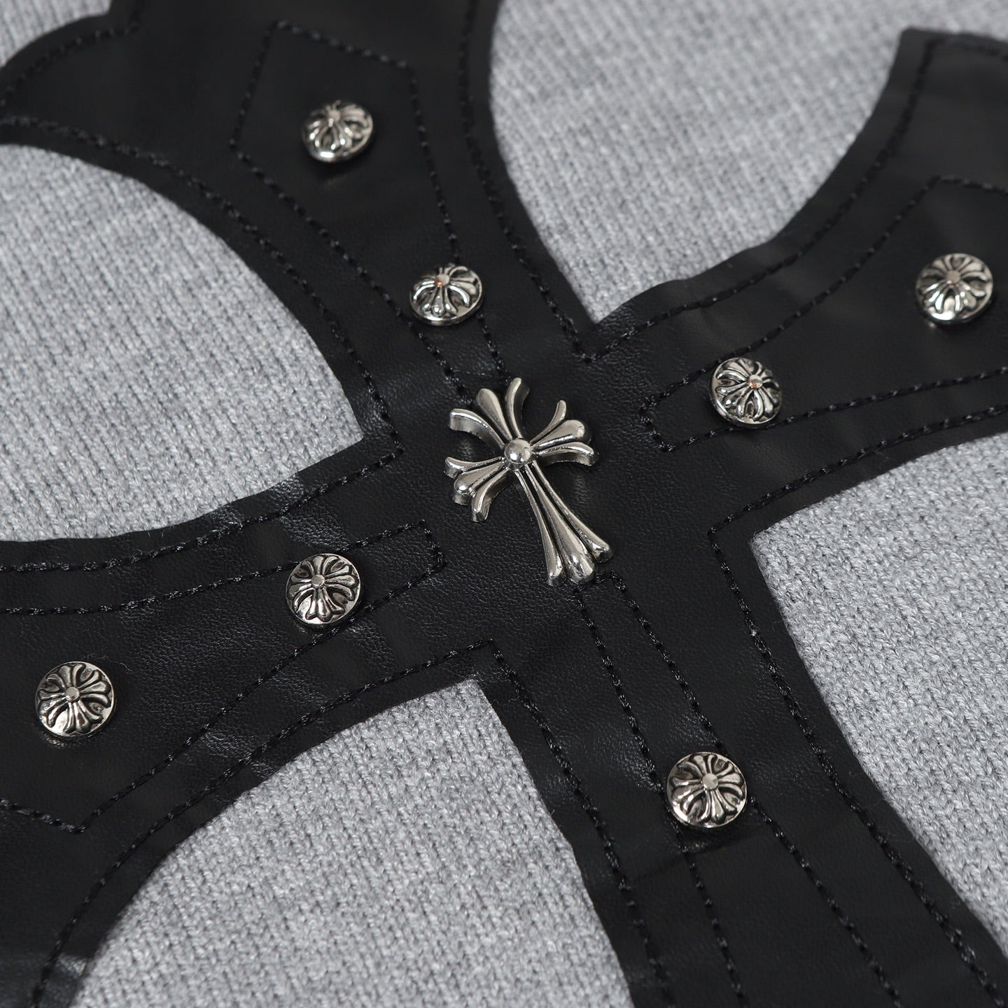 Gray hoodie front with black cross straps and silver button trim