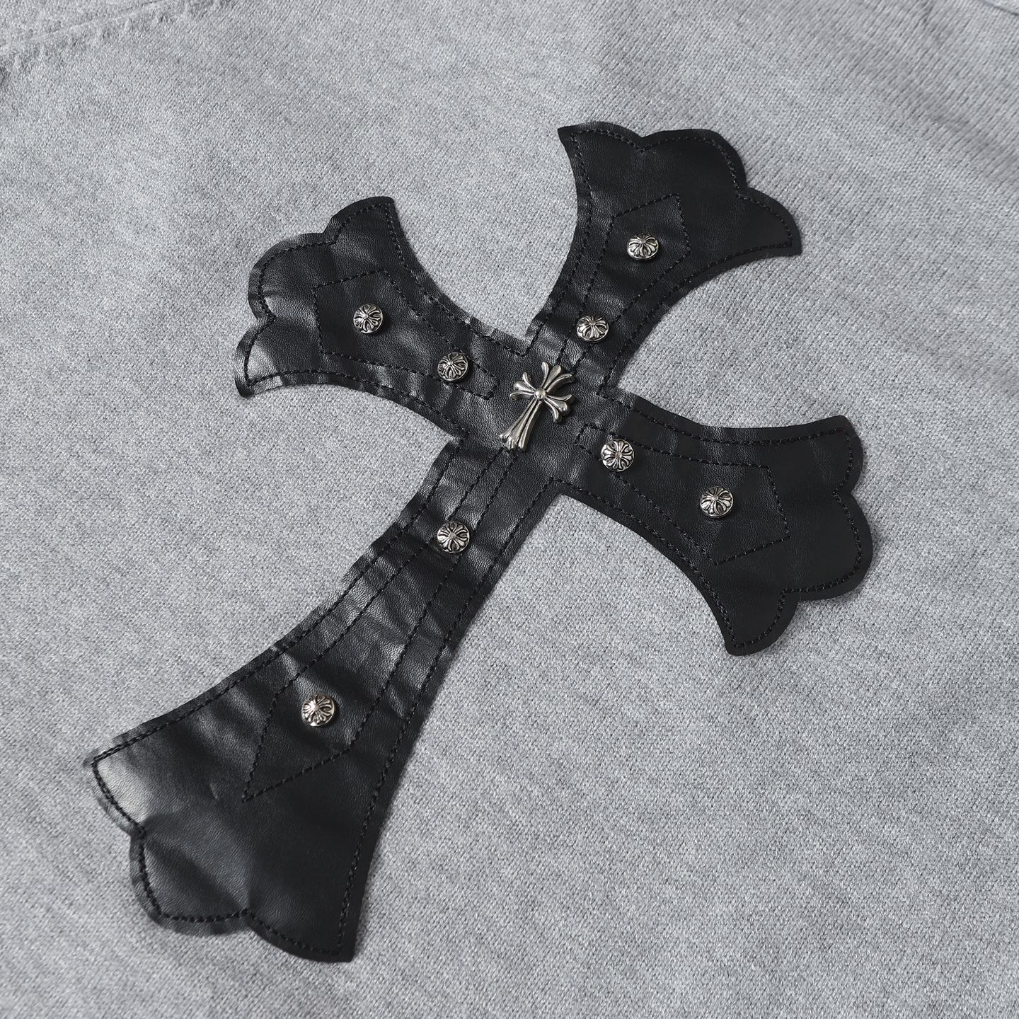 Gray hoodie with black corset-style applique, silver buttons, and bow tie