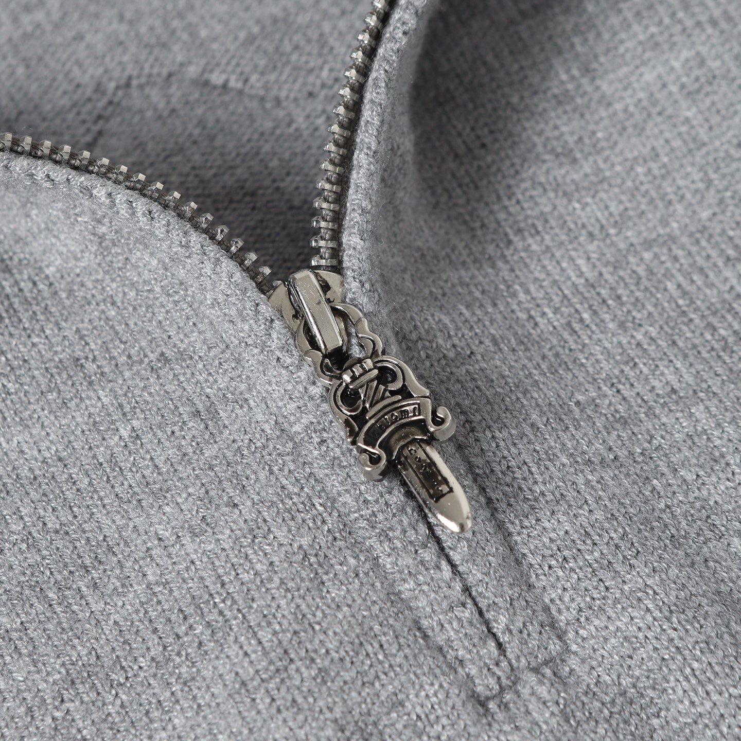 Light gray hoodie zipper with metal pull and contrast zipper tape