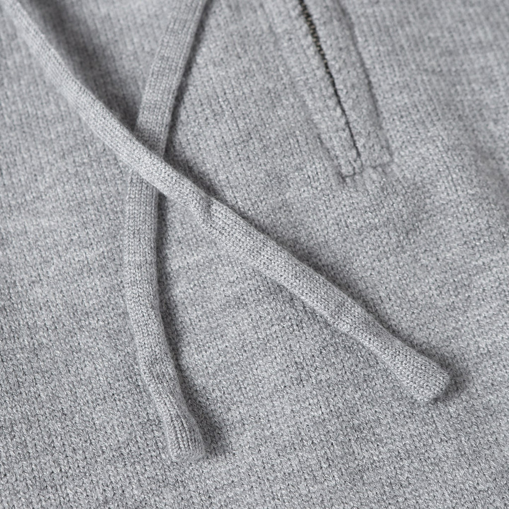 Light gray hoodie fabric with drawstring cords at the hood opening