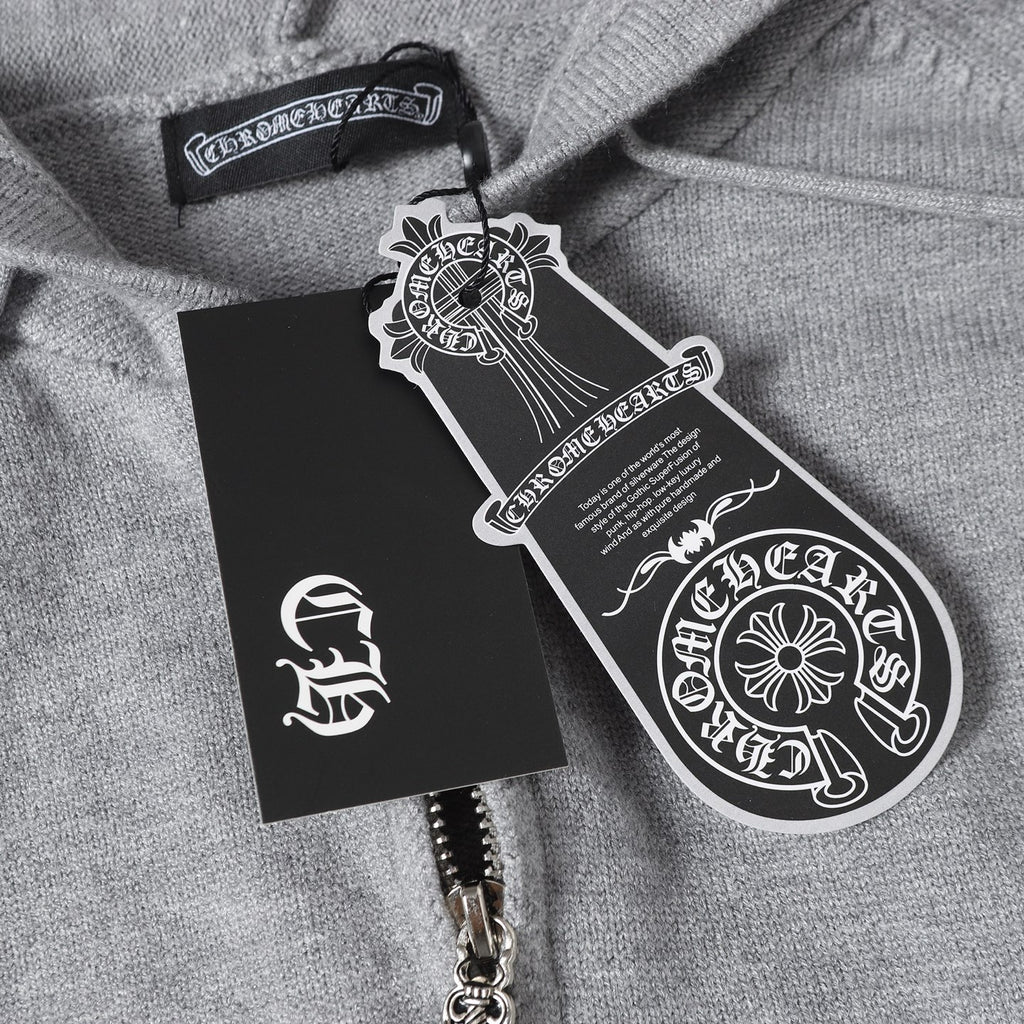 Light gray hoodie with black hang tag and product label near the zipper