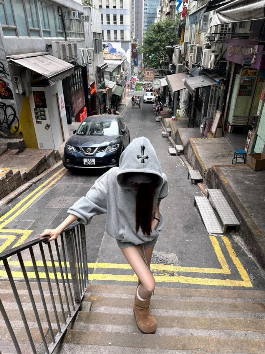 Gray hoodie with black bow-tie accents, front view on model