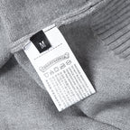 Light gray hoodie size and care label with icons and M size marker