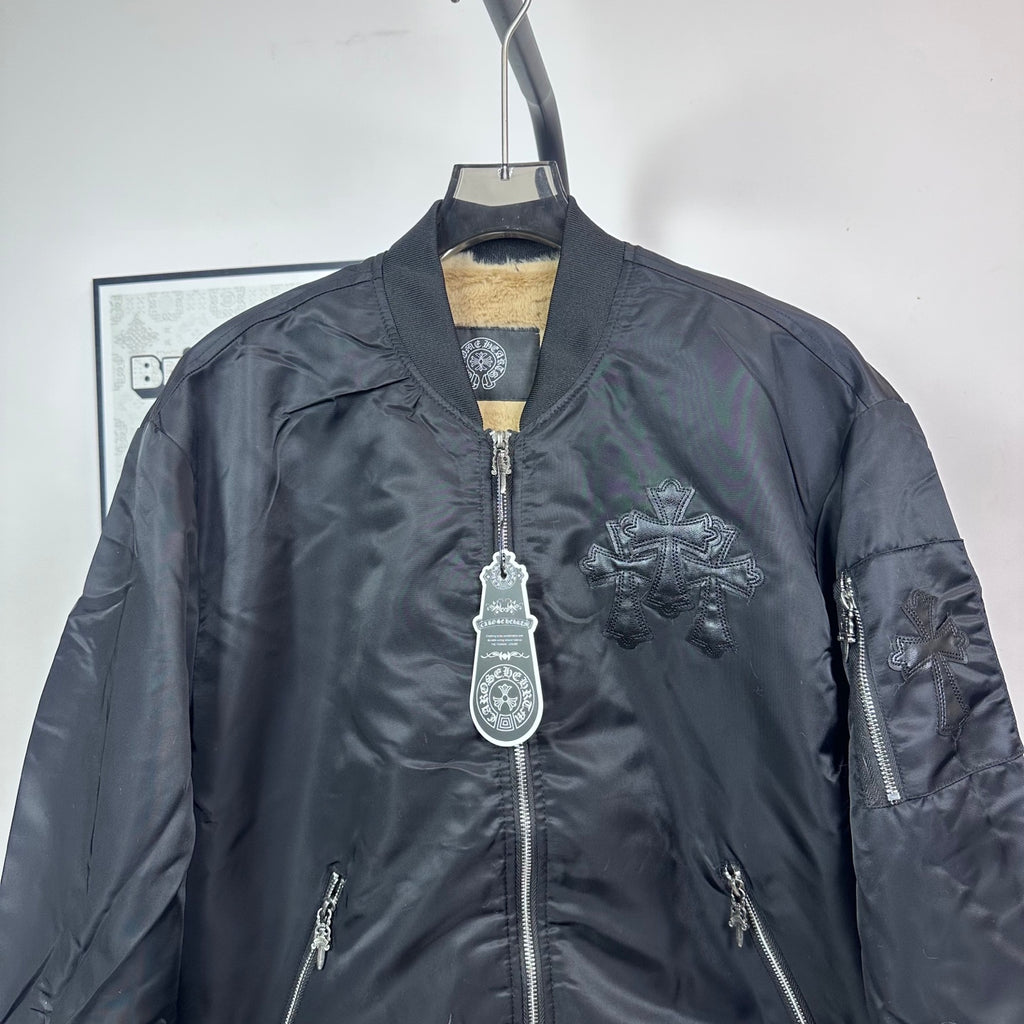 Dark blue bomber jacket front with zip closure and stitched logo cross detail