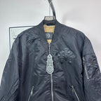 Dark blue bomber jacket front with zip closure and stitched logo cross detail