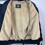 Long-sleeve jacket lining in beige sherpa with blue brand patch at chest