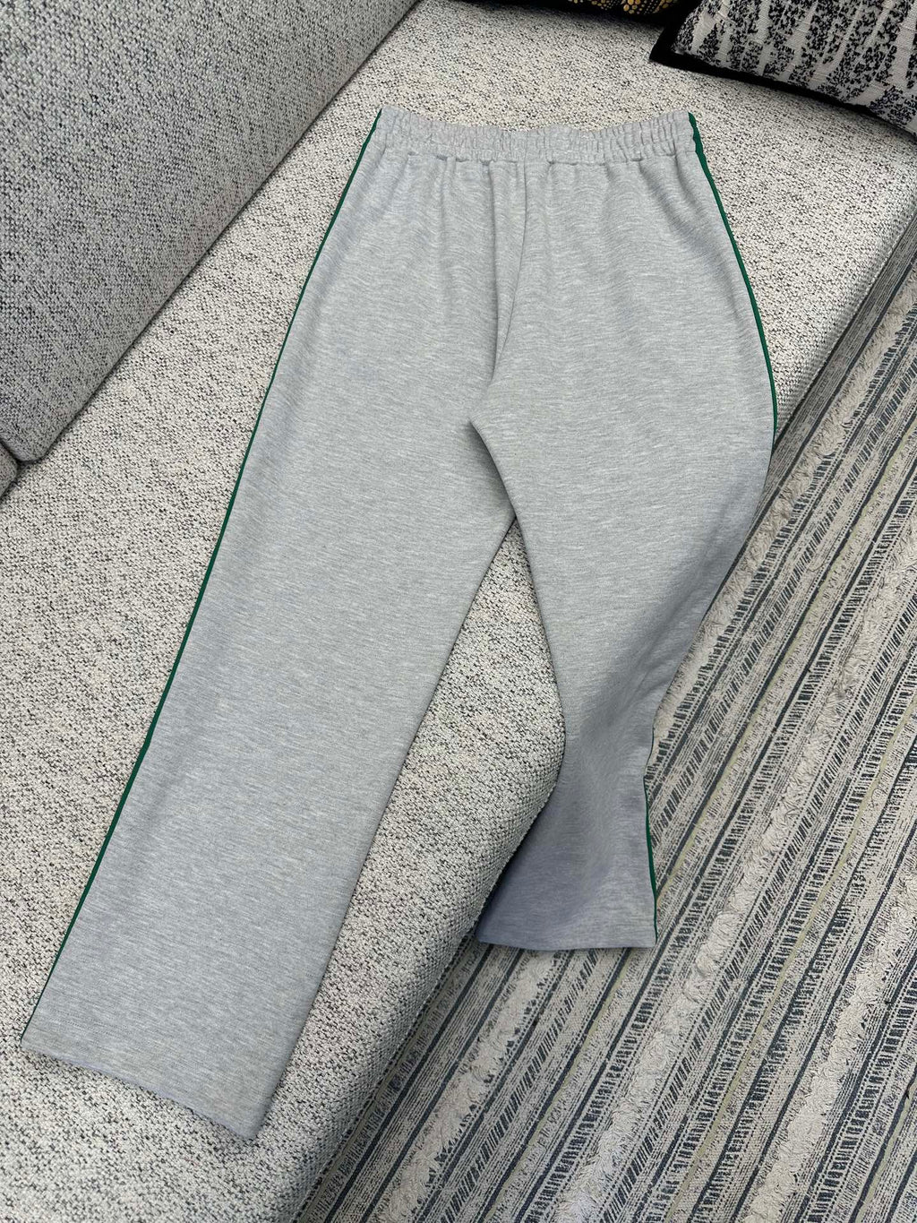 Gray Gucci track pants with wide leg and green side stripe trim