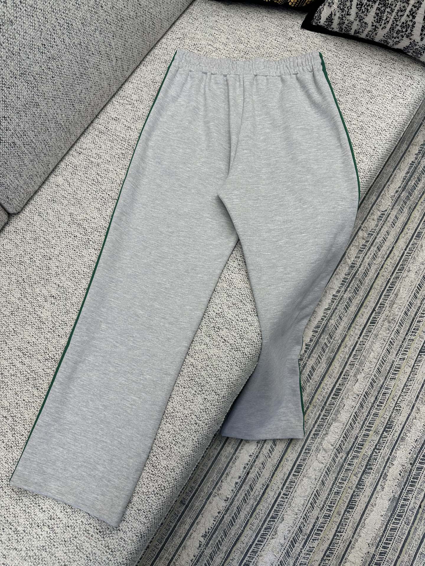 Gray Gucci track pants with wide leg and green side stripe trim