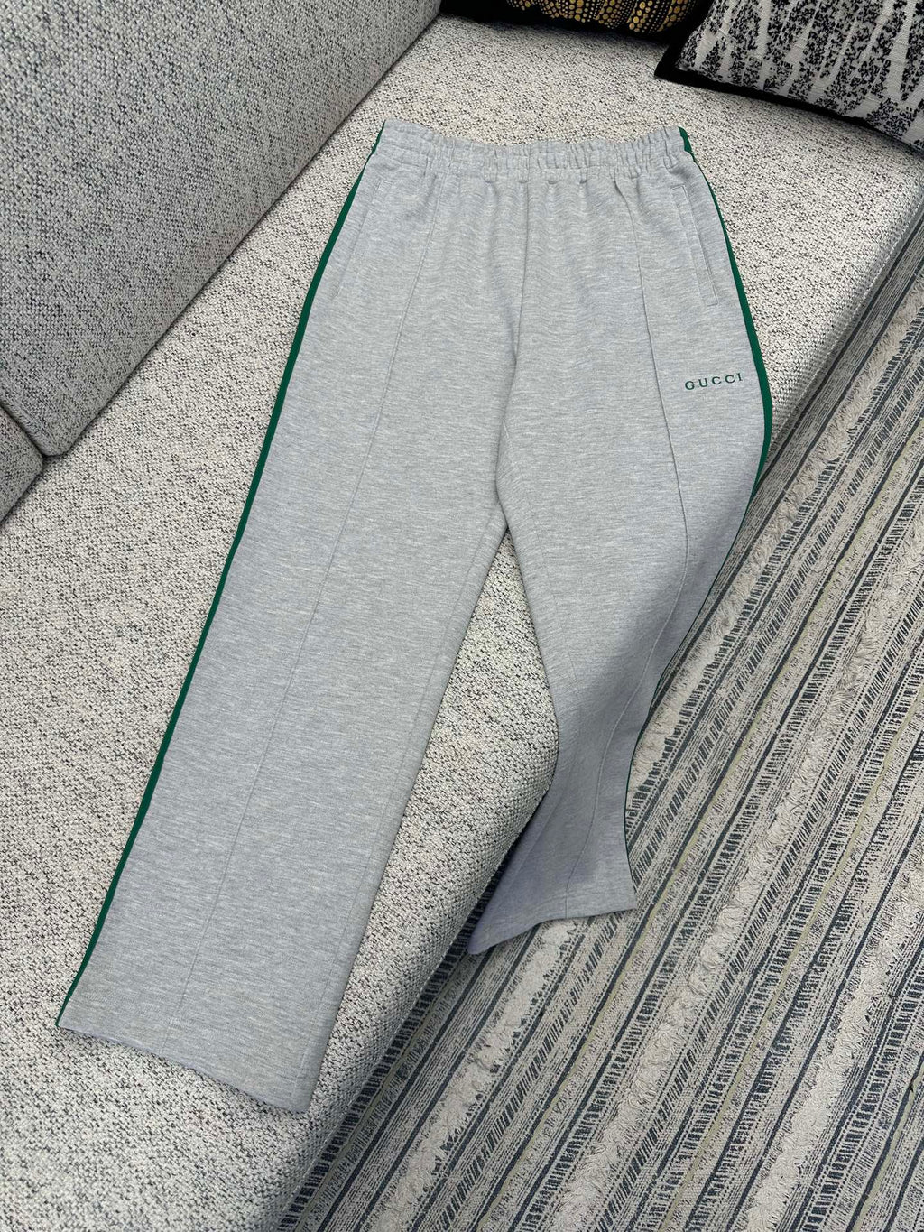 Gray Gucci track pants with elastic waist and green side stripe piping