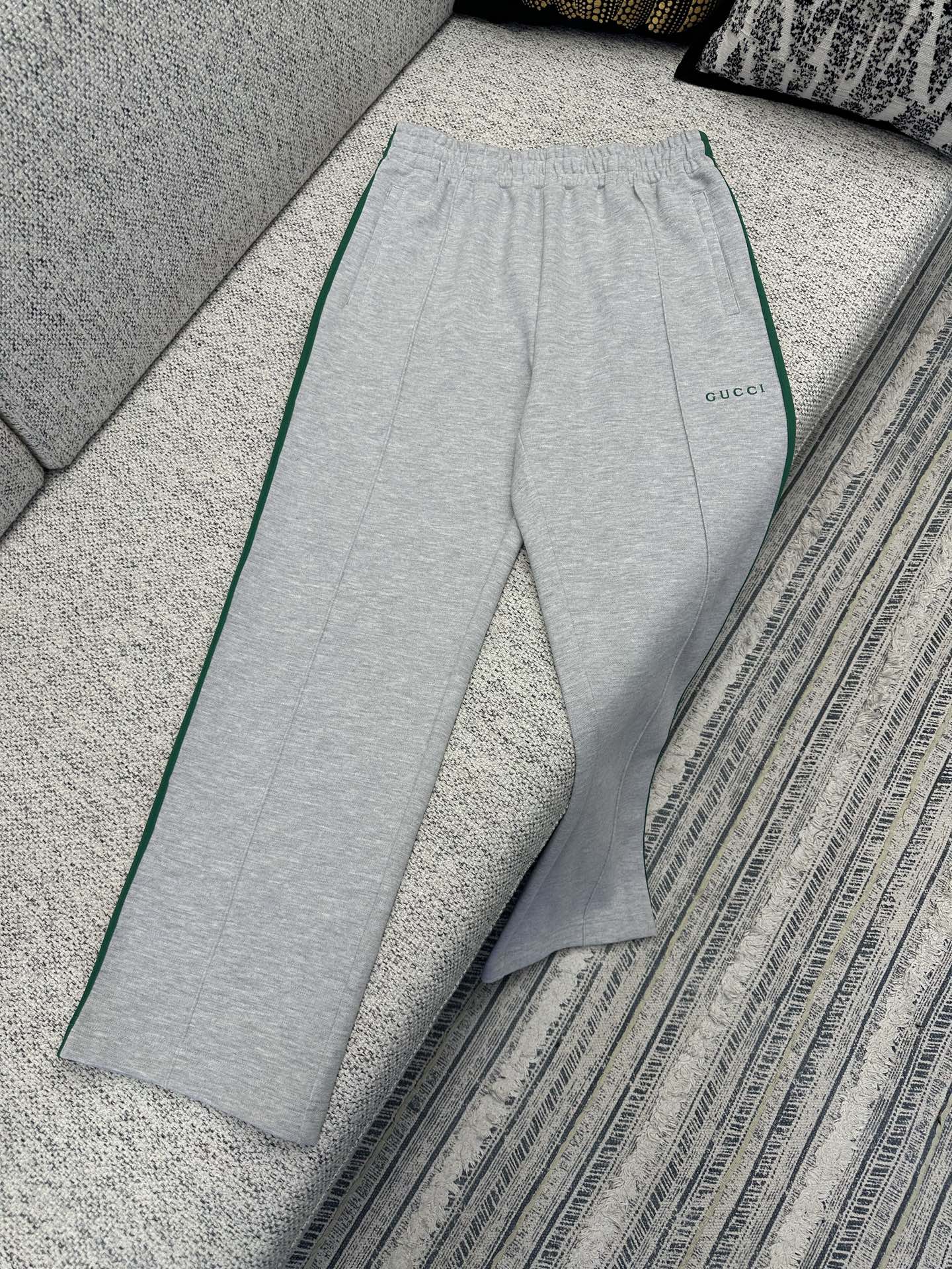 Gray Gucci track pants with elastic waist and green side stripe piping
