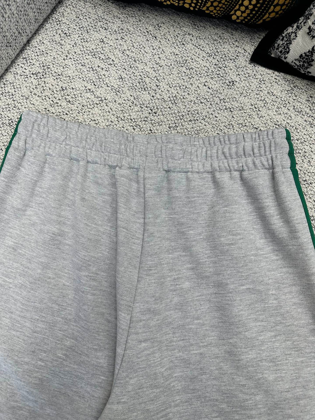 Gray Gucci track pants with elastic waistband and green side stripe trim