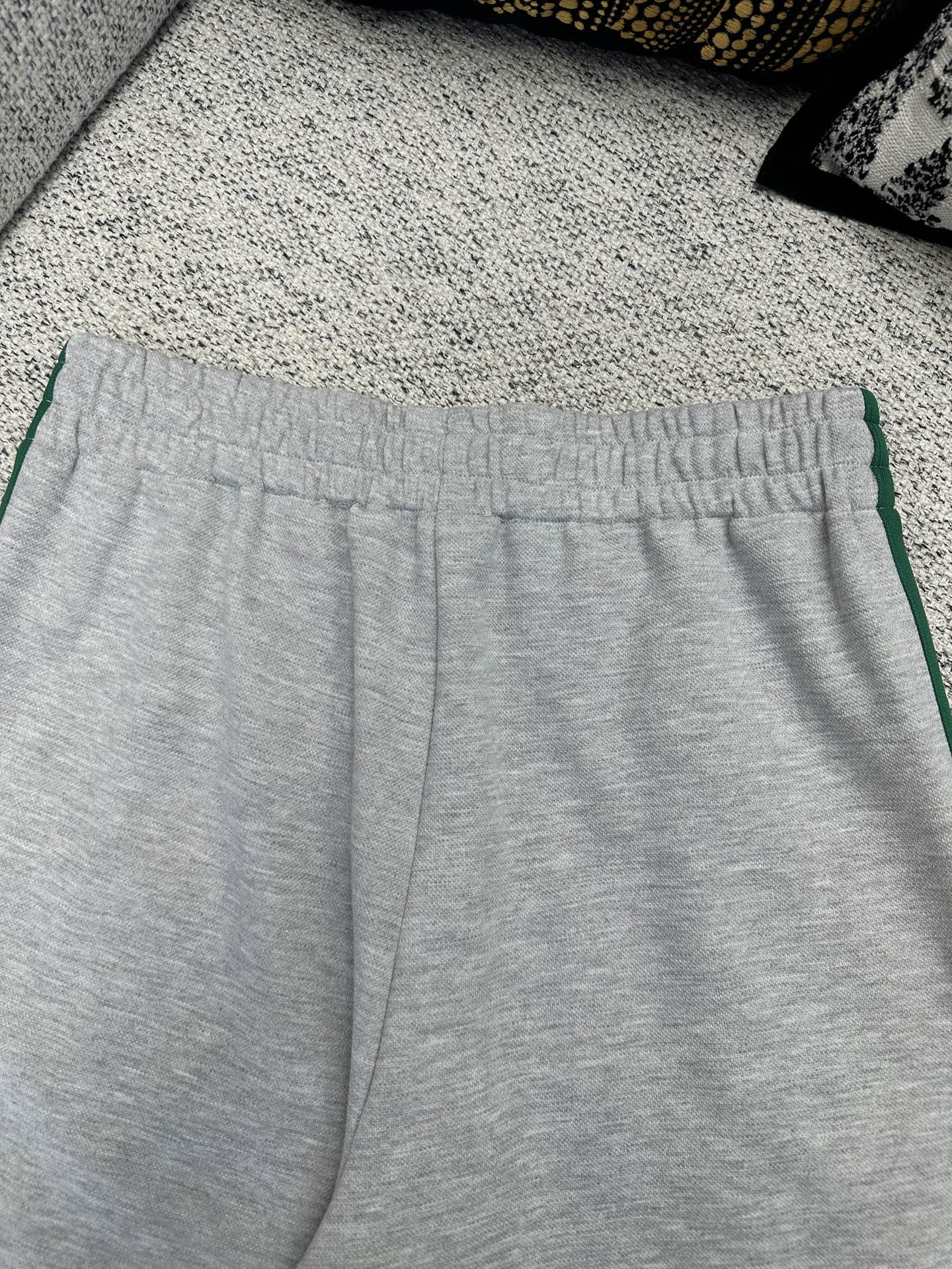 Gray Gucci track pants with elastic waistband and green side stripe trim