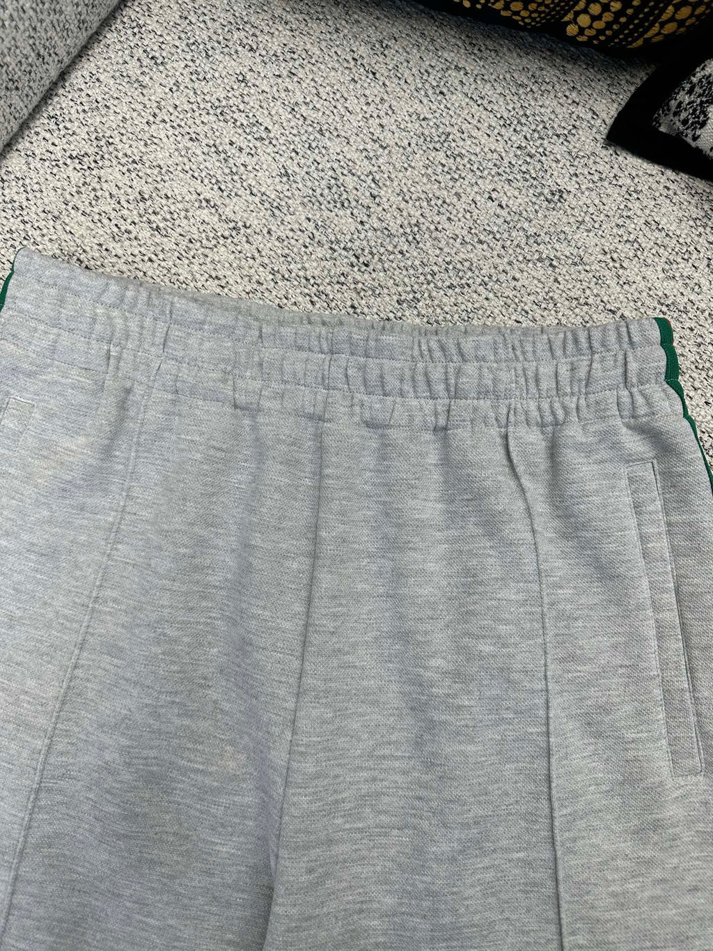 Gray Gucci track pants waistband with green stripe side trim