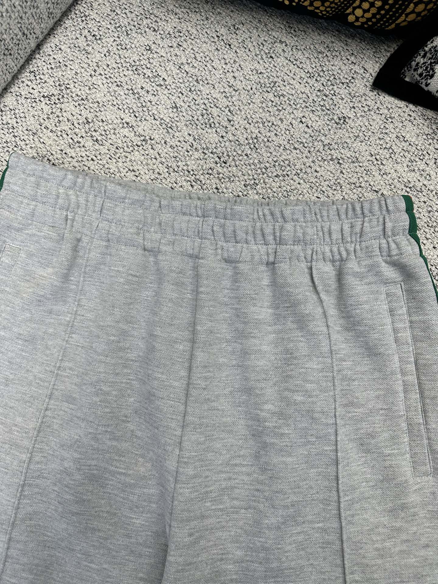 Gray Gucci track pants waistband with green stripe side trim