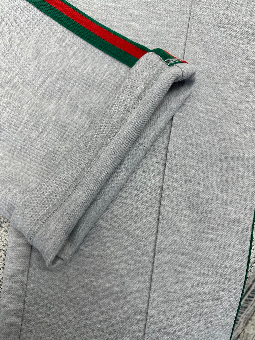 Gray Gucci pants with side stripe near hem and visible seam stitching