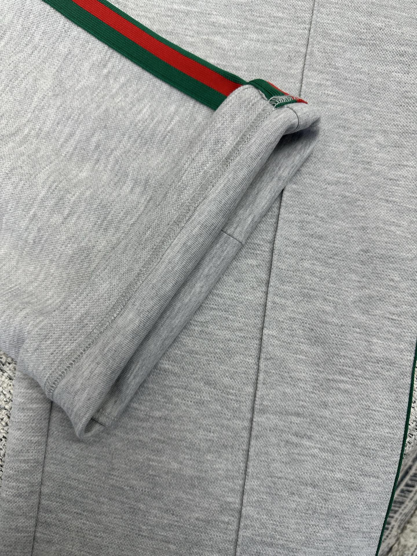 Gray Gucci pants with side stripe near hem and visible seam stitching