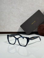 Prada eyeglass frames with dark blue-black acetate and clear lenses, logo on temple.