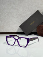 Prada eyeglass frames with purple acetate front and clear lenses, Prada logo at center.
