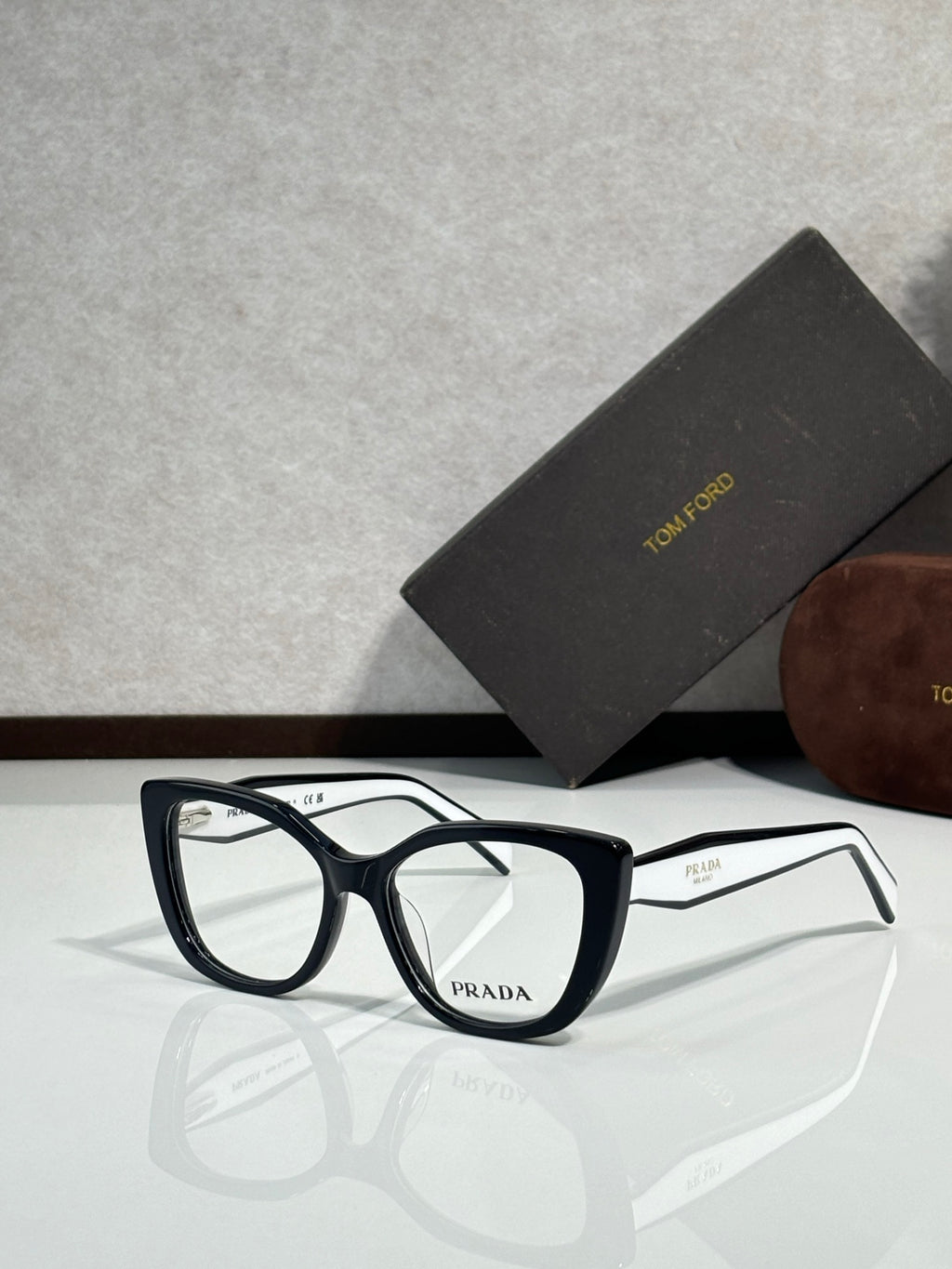 Prada eyeglasses, dark blue rectangular frames with clear lenses and Prada logo on bridge
