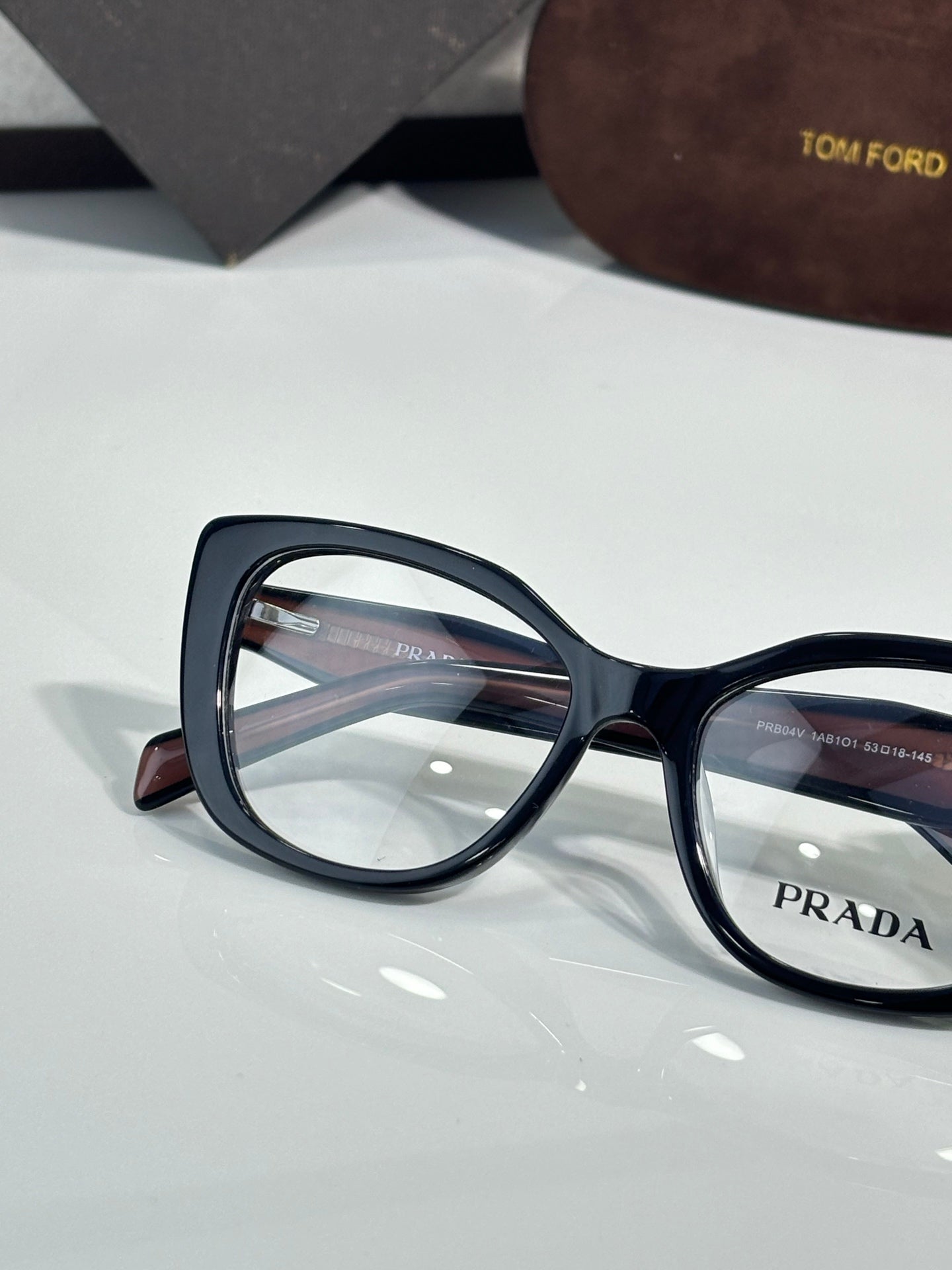 Prada eyeglasses close-up, dark blue oversized rectangular frames with clear lenses