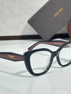 Prada eyeglasses close-up, dark blue rectangular frames with clear lenses and Prada logo