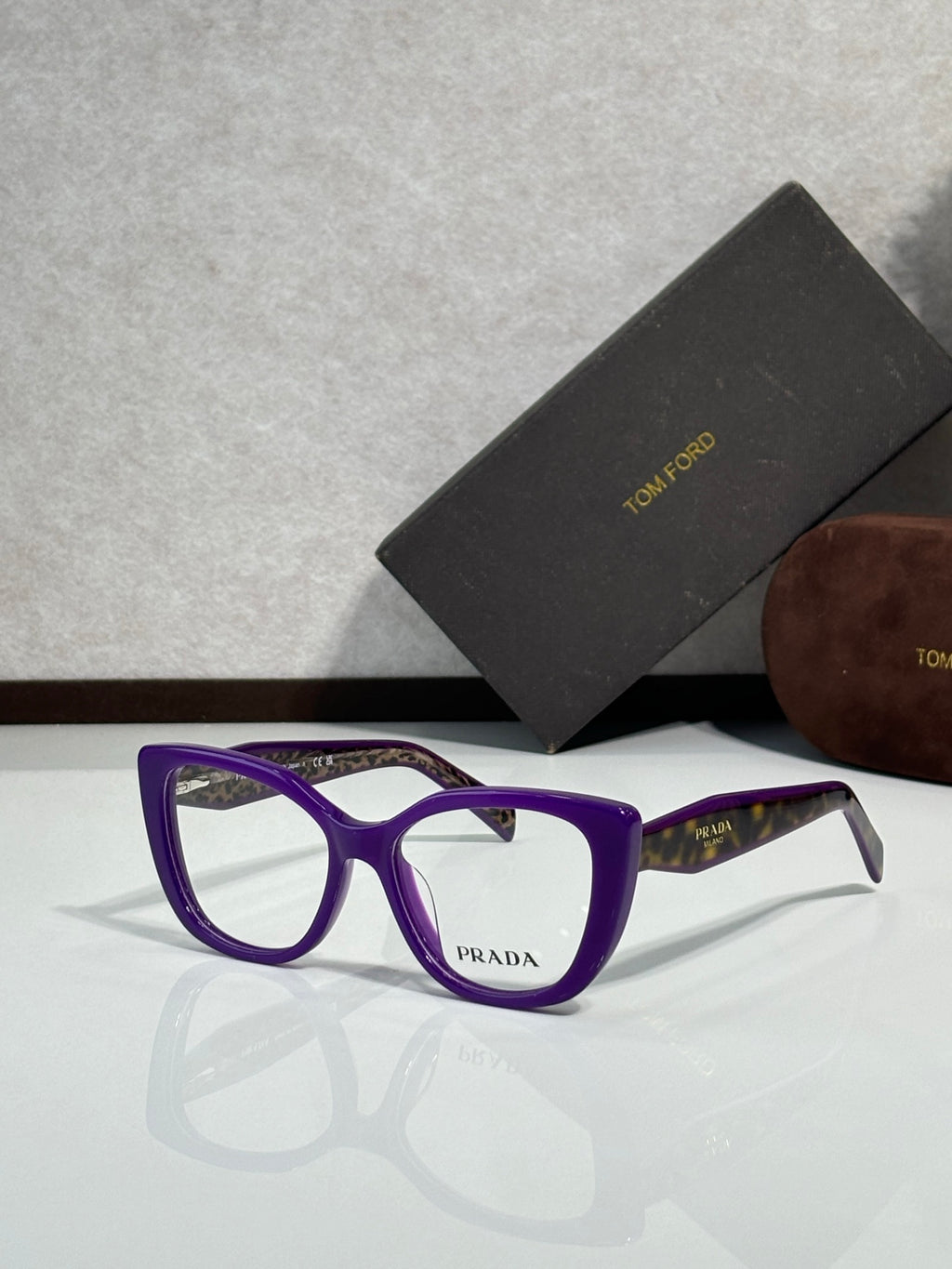 Prada eyeglasses, purple rectangular frames with clear lenses and Prada logo on front