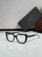 Prada eyeglasses, dark blue rectangular frames with clear lenses and Prada logo on bridge