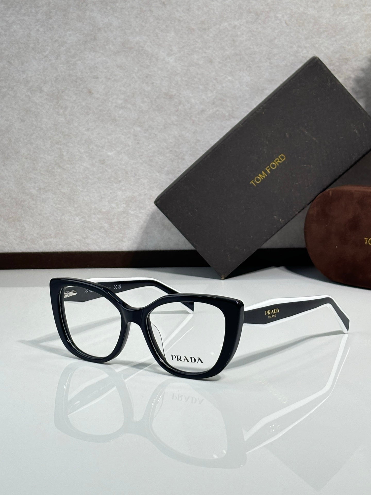 Prada eyeglasses, dark blue rectangular frames with clear lenses and Prada logo on bridge