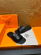 Hermes black leather slide sandals with thick wide strap and metal buckle