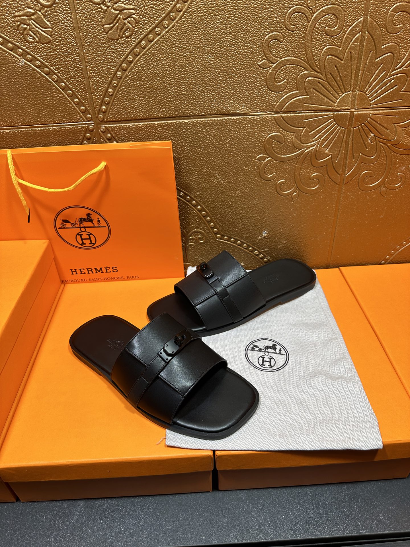 Hermes black leather slide sandals with thick wide strap and metal buckle