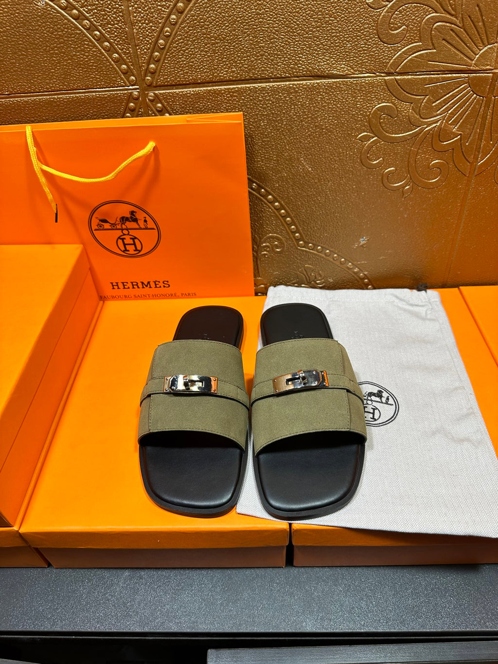 Hermes luxury sandals with olive green slide straps and silver buckle, black footbed