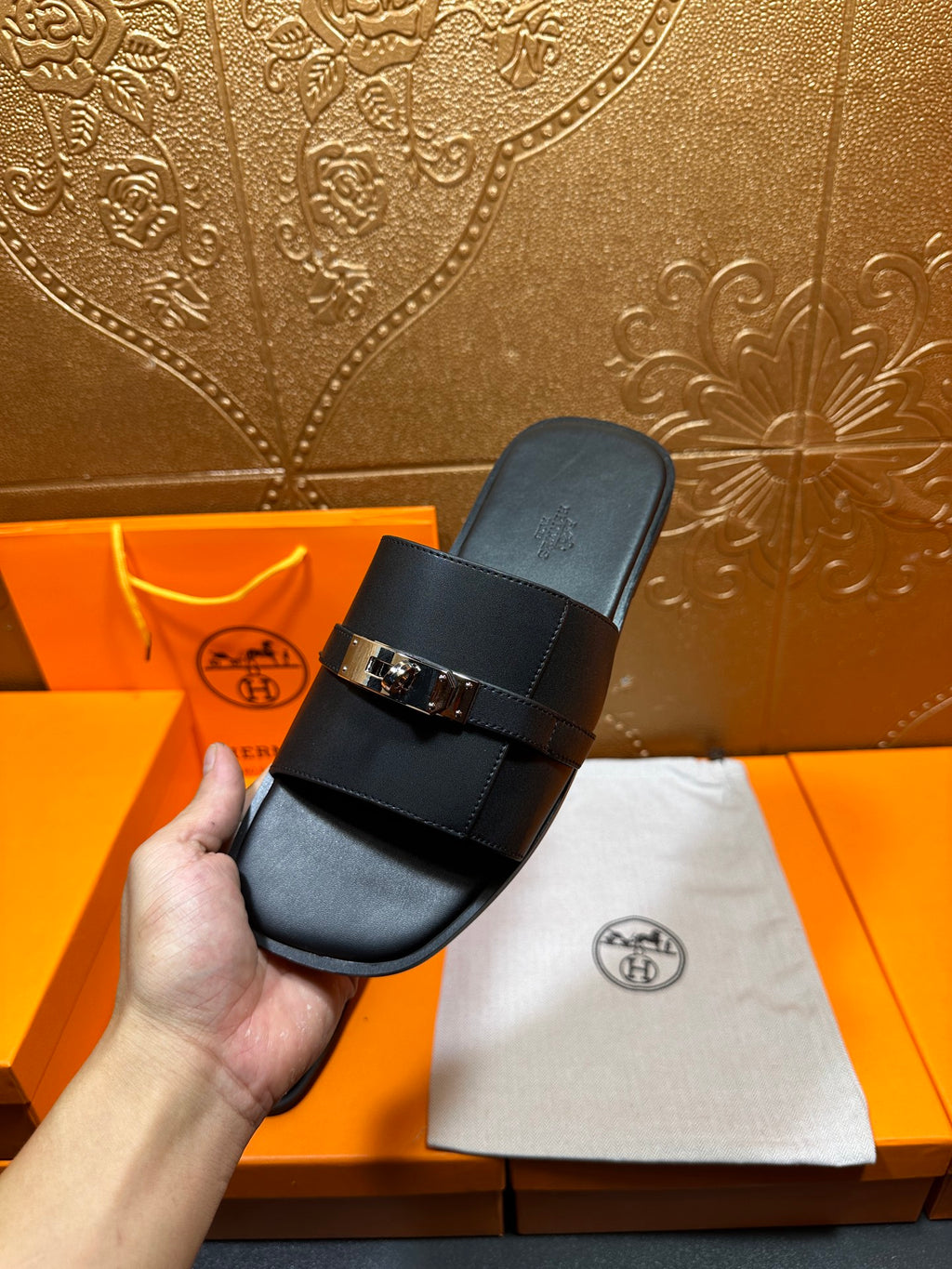 Hermes luxury black slide sandal in hand with silver-tone buckle and footbed