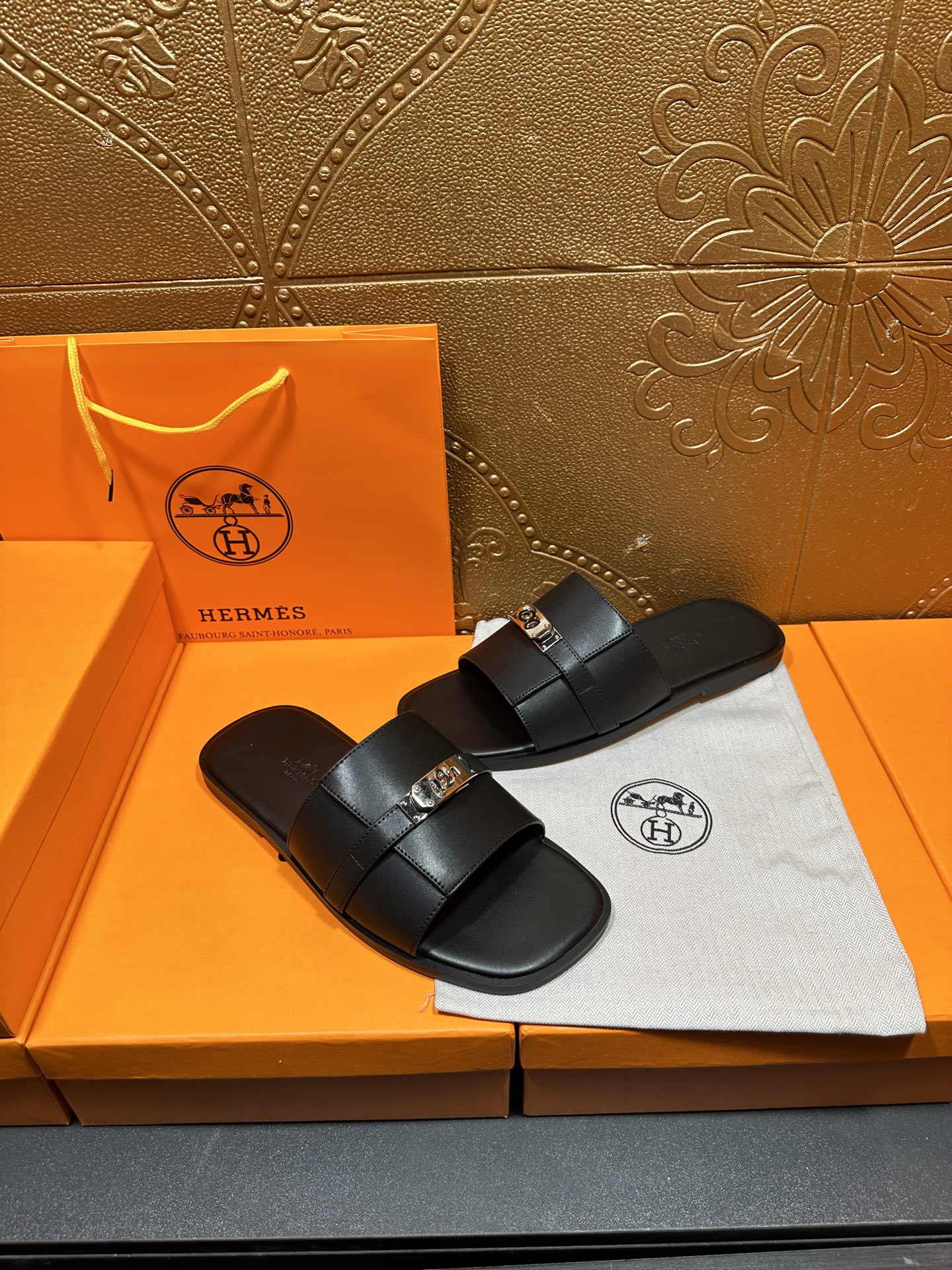 Hermes luxury black slide sandals with single wide strap and silver-tone buckle