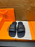 Navy leather slide sandals with adjustable strap and gold-tone buckle