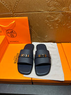 Navy leather slide sandals with adjustable strap and gold-tone buckle