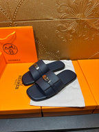 Navy leather slide sandals with double straps and gold-tone buckle