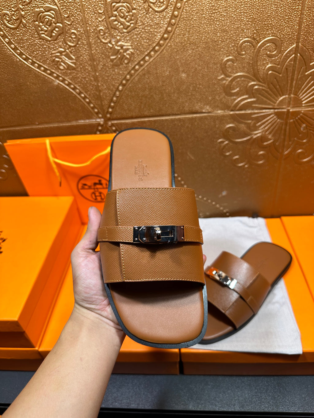 Brown leather slide sandal front view with two straps and square buckle