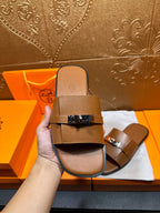 Brown leather slide sandal front view with two straps and square buckle