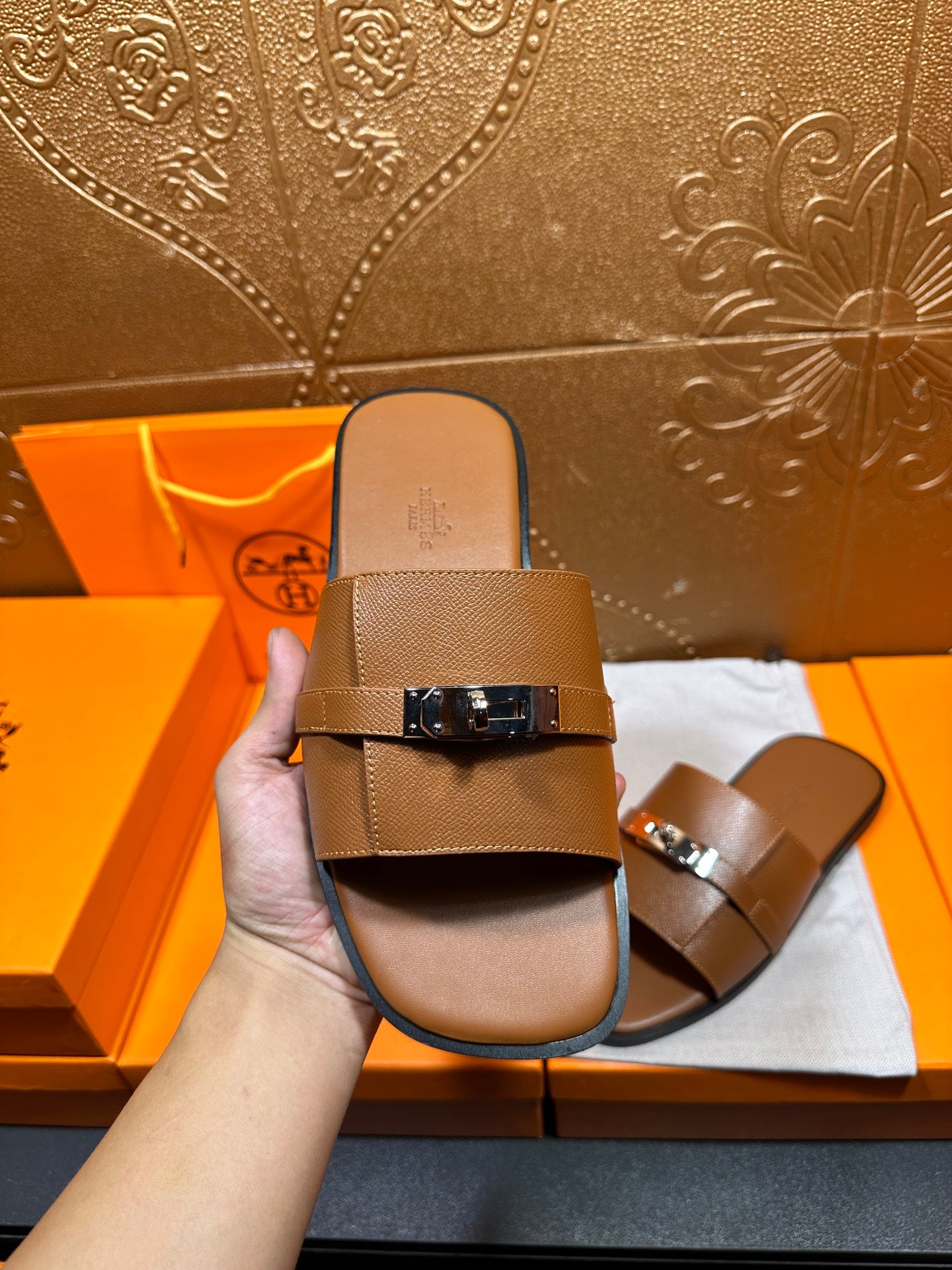 Brown leather slide sandal front view with two straps and square buckle