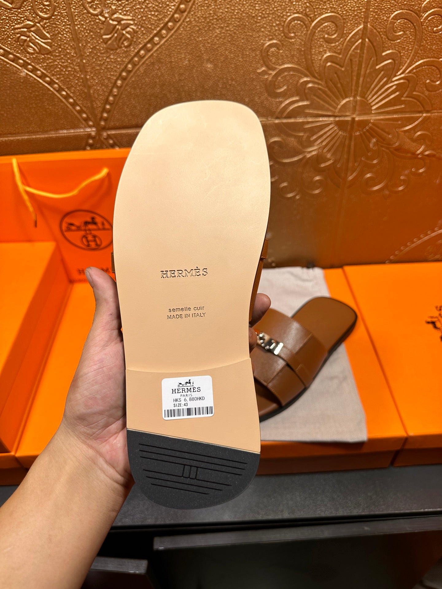 Brown leather slide sandal sole with brand stamp and grip pattern