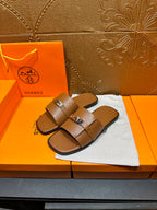 Brown leather slide sandals with two straps and square buckle, top view